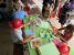 A picture of children making lots of Christmas cards