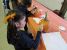 A picture of a little girl painting her pumpkin