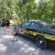 A picture of a boy by the sheriff's car