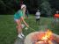 A picture of a girl toasting her s'more by the firepit